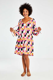 Model Olivia wearing the Sunset Gingham Tie Front Midi Dress in colour Gingham (Pink), from the front, showing the whole outfit