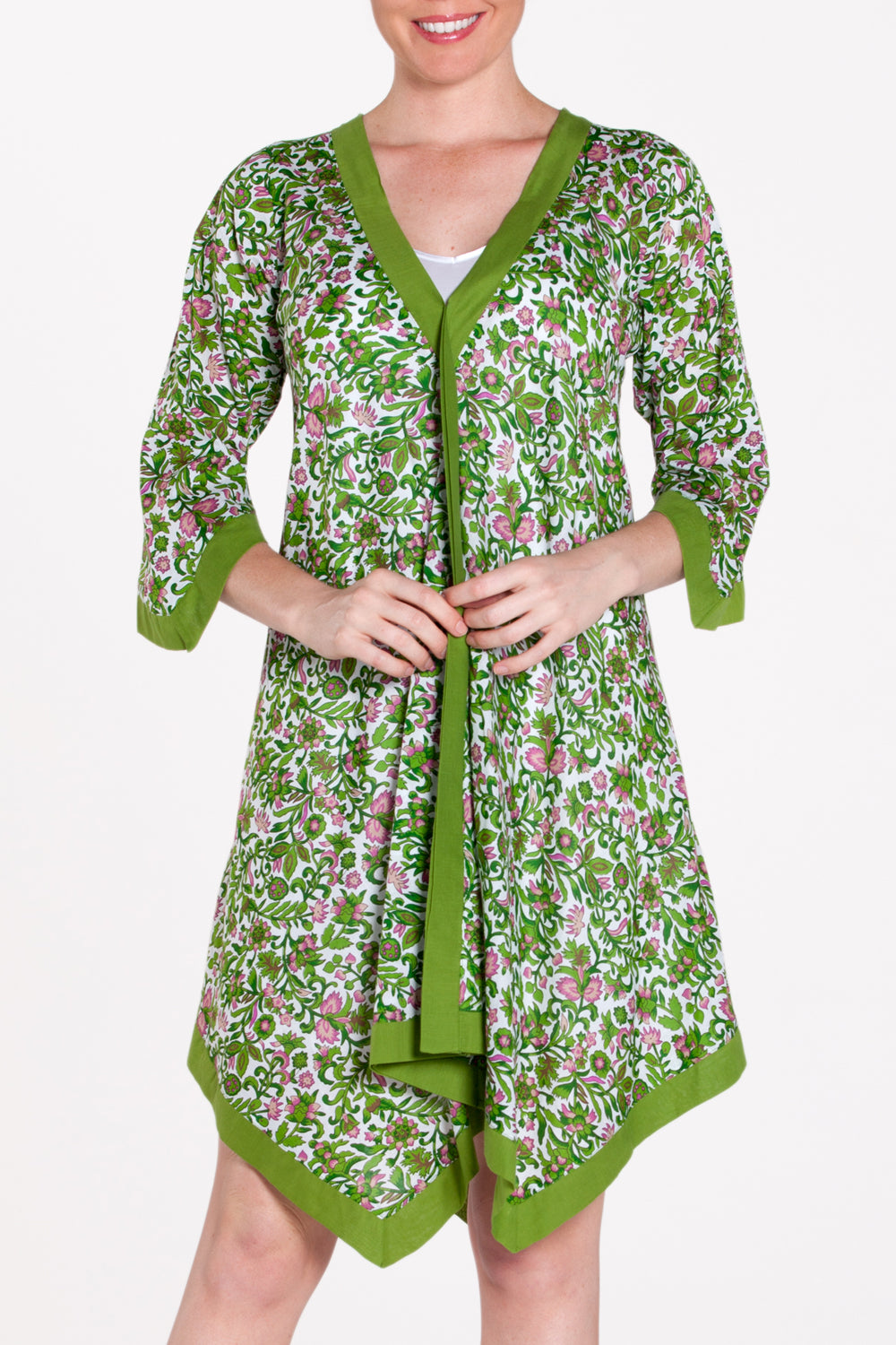 A model wearing the Libby Poncho in colour PinkFlower (Green), from the front, cropped image