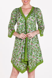 A model wearing the Libby Poncho in colour PinkFlower (Green), from the front, cropped image
