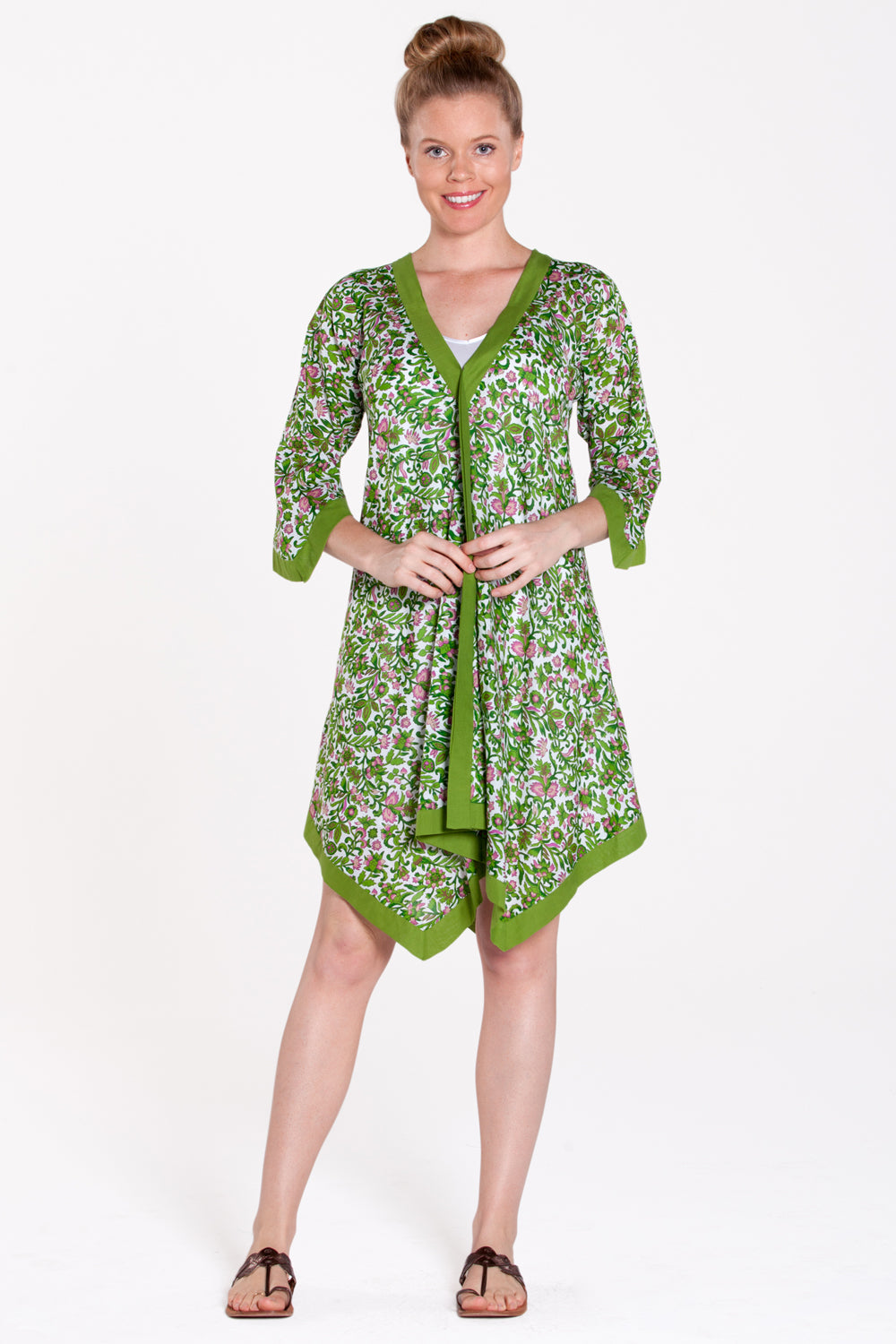 A model wearing the Libby Poncho in colour PinkFlower (Green), from the front, showing the whole outfit