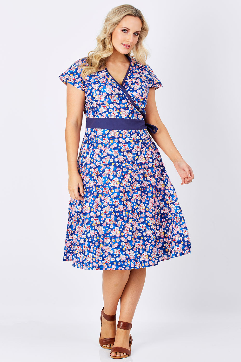 Model Jess wearing size L of the Leela Cotton Wrap Dress in colour Sakura (Blue), from the front, showing the whole outfit