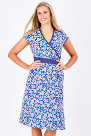 Model Maddy wearing size S of the Leela Cotton Wrap Dress in colour Sakura (Blue), from the front, cropped image
