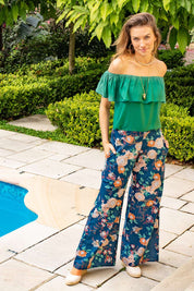 A model wearing the Sarita Pant in colour Maya (Blue), from the front, showing the whole outfit