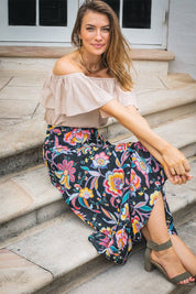 A model wearing the Ole Skirt in colour Castro (Black), from the front, showing the whole outfit