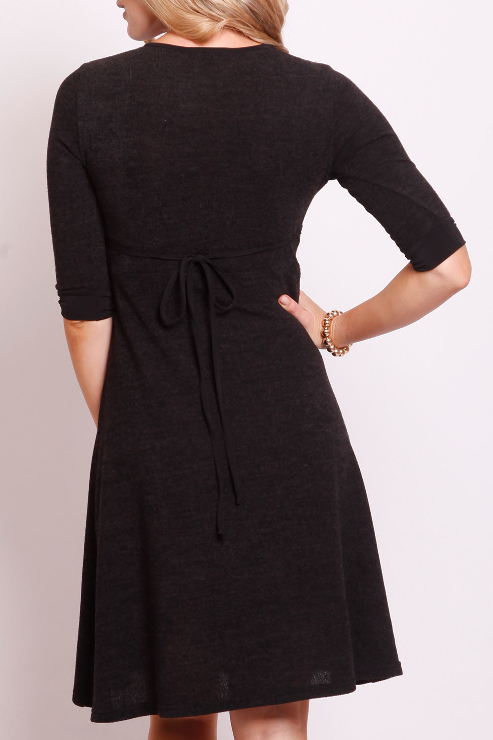 A model wearing the Maree Cross Bust Dress W Tie in colour DkCharcoal (Black), from the back