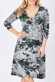 Model Jess wearing size M of the Betty Wrap Dress in colour Print (Black), from the front, cropped image