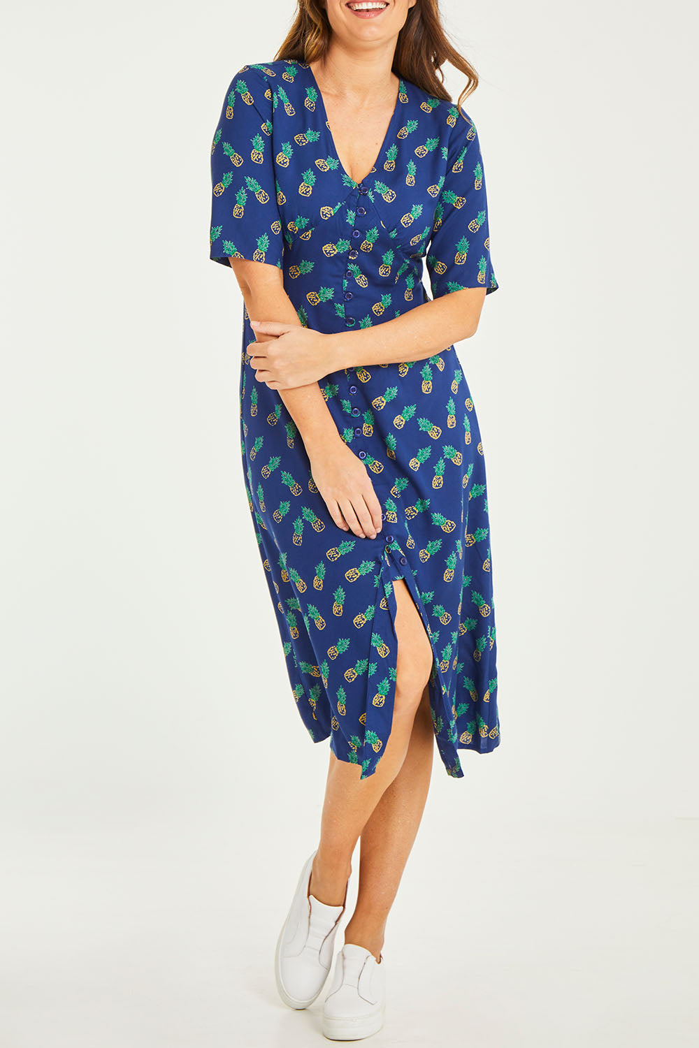 Model Georgia wearing size 10 of the Frenchie Dress in colour Pinapples (Blue), from the front, cropped image