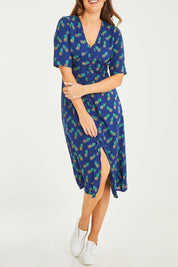 Model Georgia wearing size 10 of the Frenchie Dress in colour Pinapples (Blue), from the front, cropped image