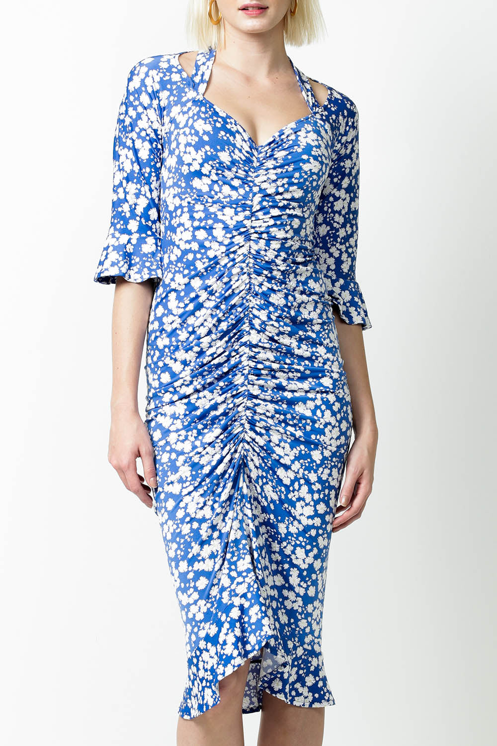 A model wearing the Somerland Ruched Dress in colour Bluedaisy (Blue), from the front, cropped image