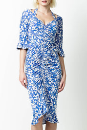 A model wearing the Somerland Ruched Dress in colour Bluedaisy (Blue), from the front, cropped image