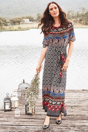 Model Clementine wearing size 10 of the Villia Lina Maxi in colour BorderPrnt (Grey), from the front, showing the whole outfit