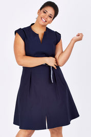 Model Shareefa wearing size 18 of the Fit & Flare Belted Dress in colour Navy (Blue), from the front, cropped image