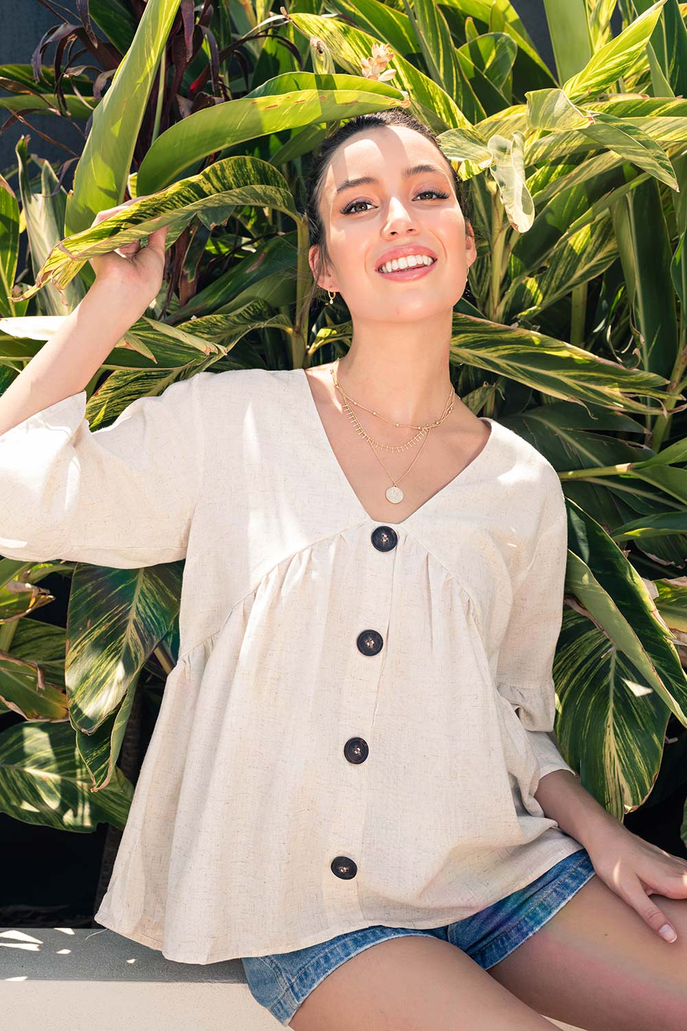 A model wearing the Sand Top in colour Sand, from the front, showing the whole outfit