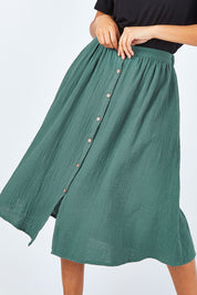 Model Summer wearing size 10 of the Lost Dreams Buttoned Skirt in colour Forest (Green), from the front, cropped image