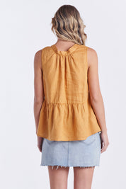 A model wearing the Savannah Top in colour Pawpaw, from the back
