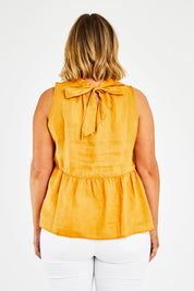 Model Jess wearing size 14 of the Savannah Top in colour Pawpaw, from the back