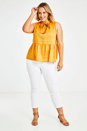 Model Jess wearing size 14 of the Savannah Top in colour Pawpaw, from the front, showing the whole outfit