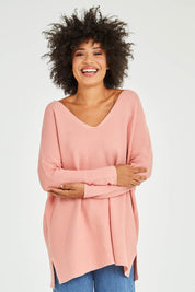 Model Olivia wearing size 10 of the Amanda Knit in colour Candy (Pink), from the front, cropped image