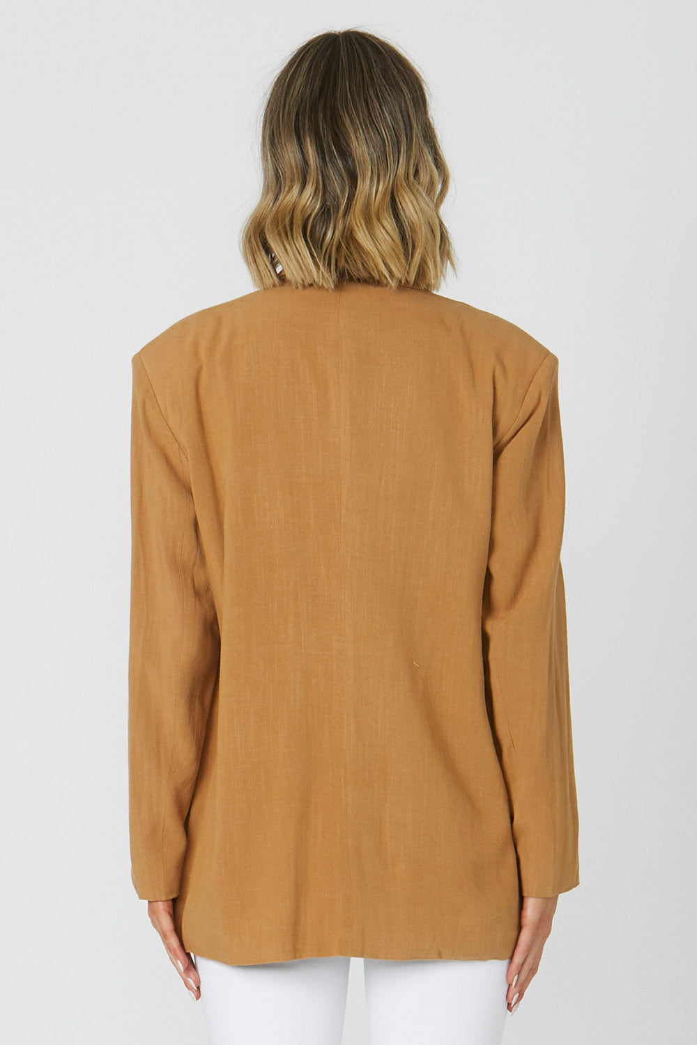 A model wearing the Alexis Blazer in colour Toffee, from the back