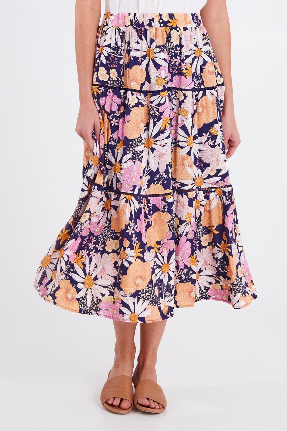 Model Madeline wearing size 10 of the Montana Tiered Skirt in colour Navyfloral (Blue), from the front, cropped image
