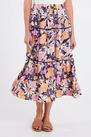 Model Madeline wearing size 10 of the Montana Tiered Skirt in colour Navyfloral (Blue), from the front, cropped image