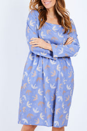 Model Laura wearing size 14 of the Naktergal Dress in colour Nightingal (Blue), from the front, cropped image