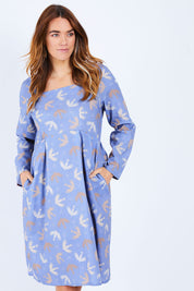 Model Laura wearing size 14 of the Naktergal Dress in colour Nightingal (Blue), from the front, cropped image