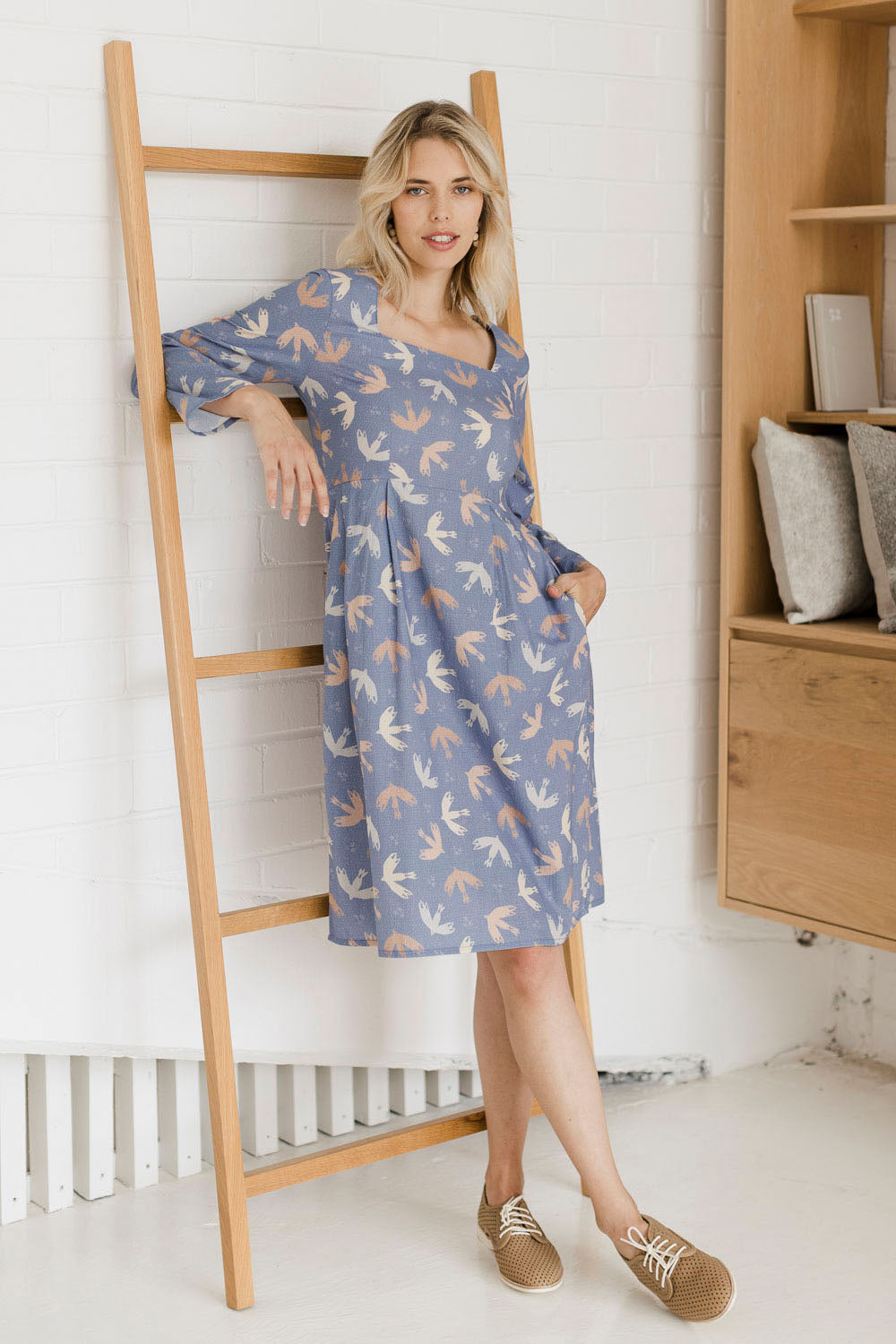 Model Phoebe wearing size 10 of the Naktergal Dress in colour Nightingal (Blue), from the front, showing the whole outfit