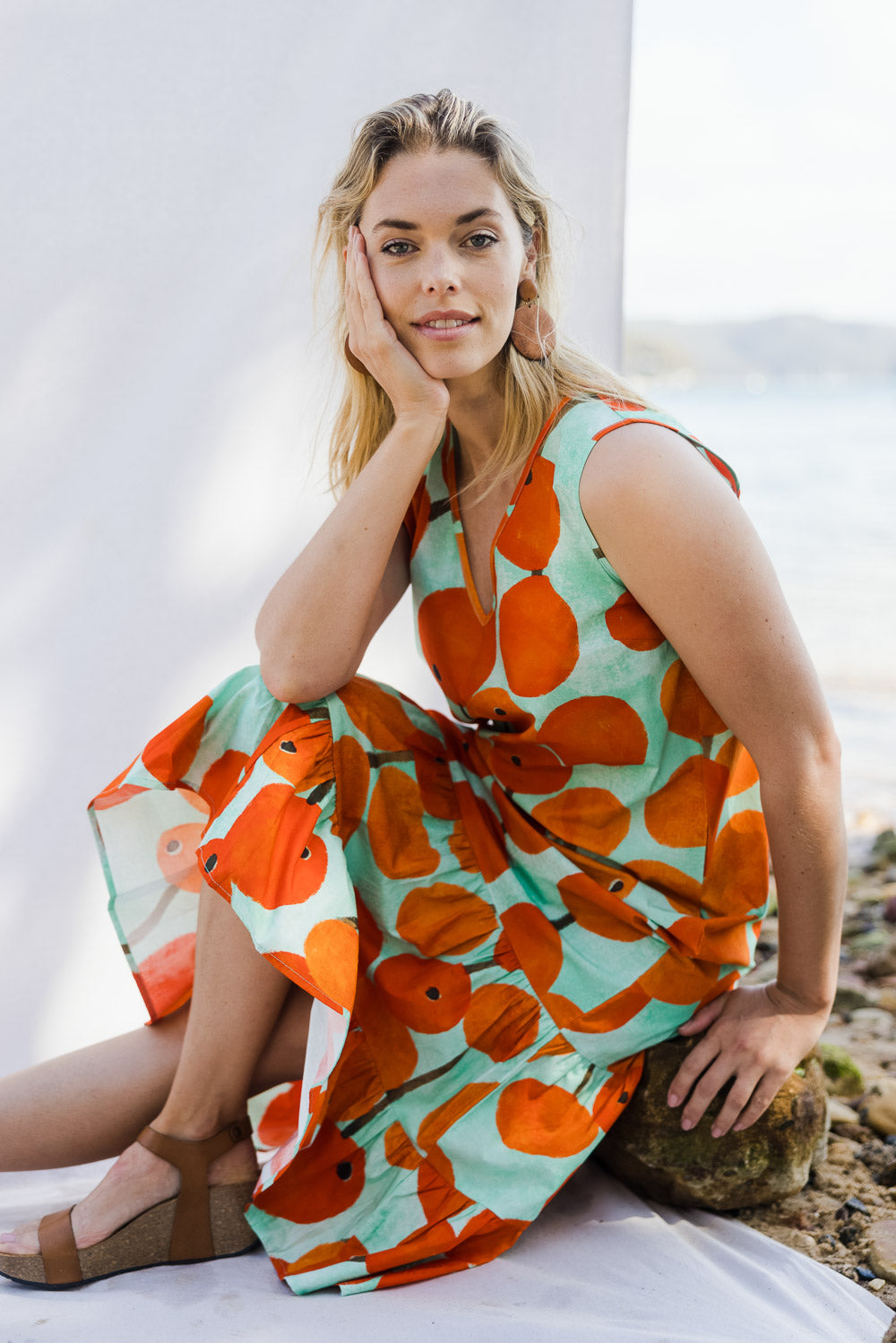 Model Phoebe wearing size 10 of the Svangande Dress in colour Redberry (Red), from the front, showing the whole outfit