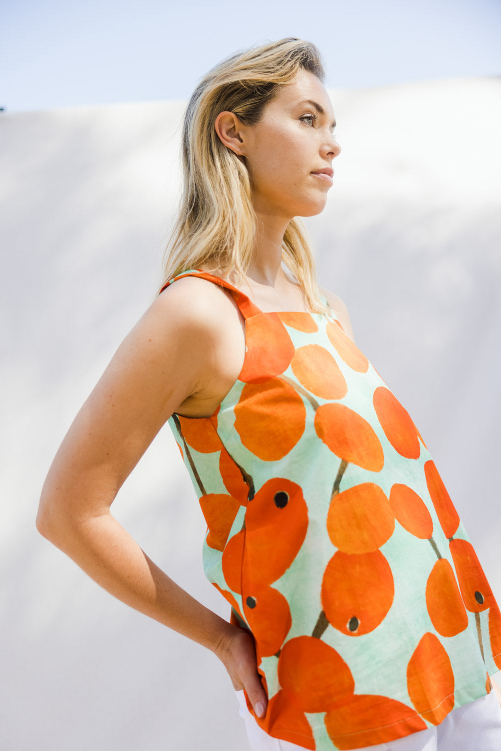 Model Phoebe wearing size 10 of the Undra Tank in colour Redberry (Red), from the front, showing the whole outfit