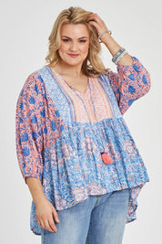 Model Keeara wearing size 16 of the Rosebud Beach Blouse in colour Coralblue (Blue), from the front, cropped image