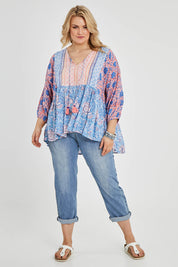 Model Keeara wearing size 16 of the Rosebud Beach Blouse in colour Coralblue (Blue), from the front, showing the whole outfit