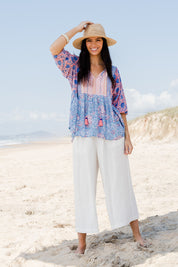 Model Stacey wearing size 10 of the Rosebud Beach Blouse in colour Coralblue (Blue), from the front, showing the whole outfit