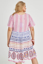 Model Keeara wearing size 16 of the Sealers Cove Cotton Dress in colour Multi (Red), from the back