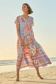 Model Riina wearing size 10 of the Mindil Beach Maxi Dress in colour Patchwork, from the front, showing the whole outfit