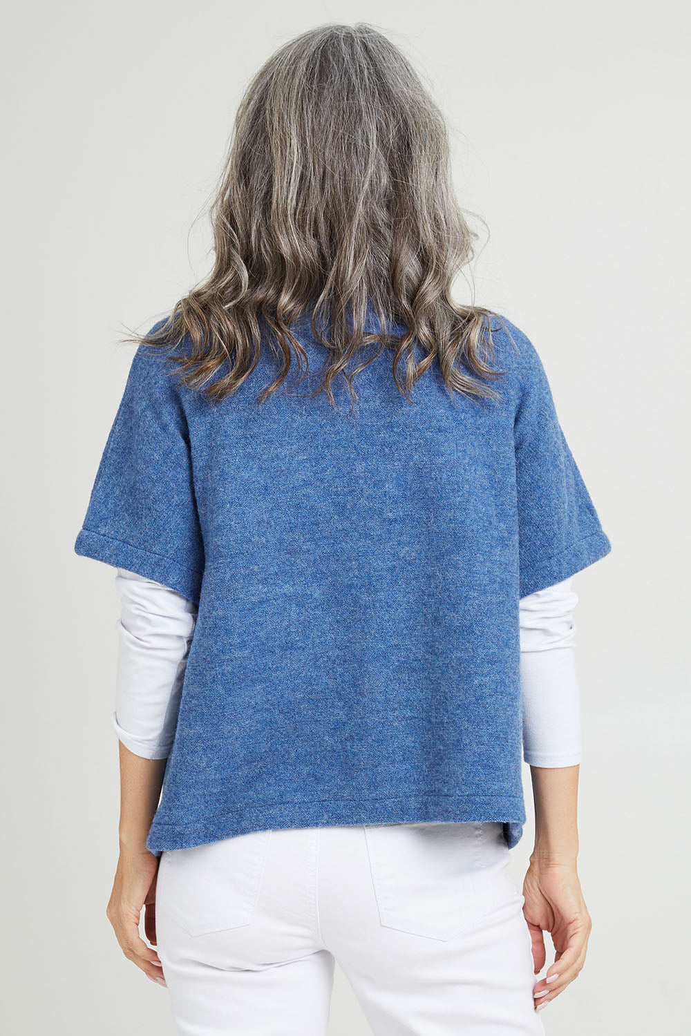 Model Luisa wearing size S of the Button Thru Vest in colour Denim (Blue), from the back
