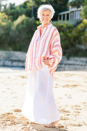 Model Elise wearing size S of the Milano Shirt in colour Santstrip (Pink), from the front, showing the whole outfit
