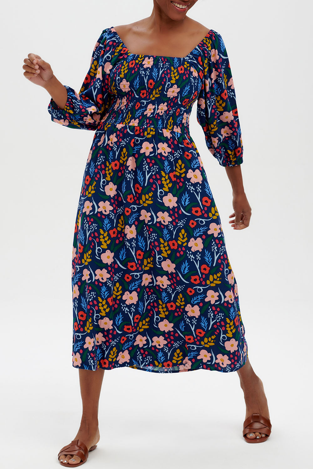 A model wearing the Raquel Shirred Dress in colour Blue (Blue), from the front, cropped image