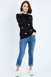Model Andrea wearing size 10 of the Rita Starburst Sweater in colour Blackmulti (Black), from the front, showing the whole outfit