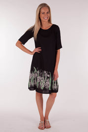A model wearing size 10 of the Robbie Shift Dress Summer Meadow in colour JetBlack (Black), from the front, showing the whole outfit
