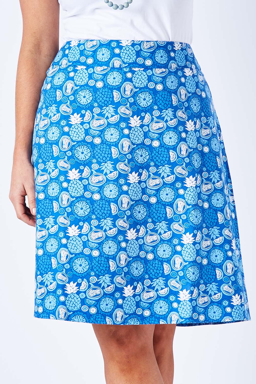 Model Laura wearing size 12 of the Adele Ain colourline Skirt Fruit Punch - Blue (Blue), from the front, cropped image