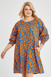Model Keeara wearing size 16 of the Frankie Shift Dress in colour Leaf, from the front, cropped image