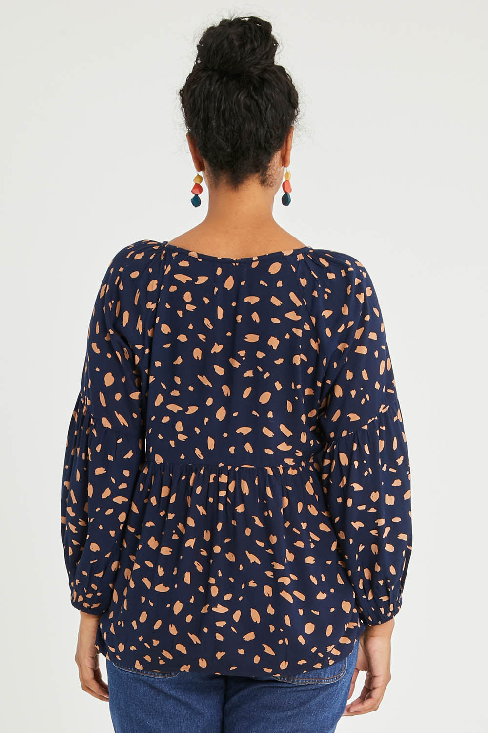 Model Noli wearing size 14 of the Dianna Blouse in colour Spot (Blue), from the back