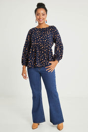 Model Noli wearing size 14 of the Dianna Blouse in colour Spot (Blue), from the front, showing the whole outfit