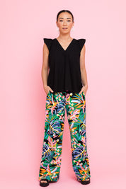 Model Katie wearing size 10 of the Stella Print Pant in colour Rainforest (Blue), from the front, showing the whole outfit