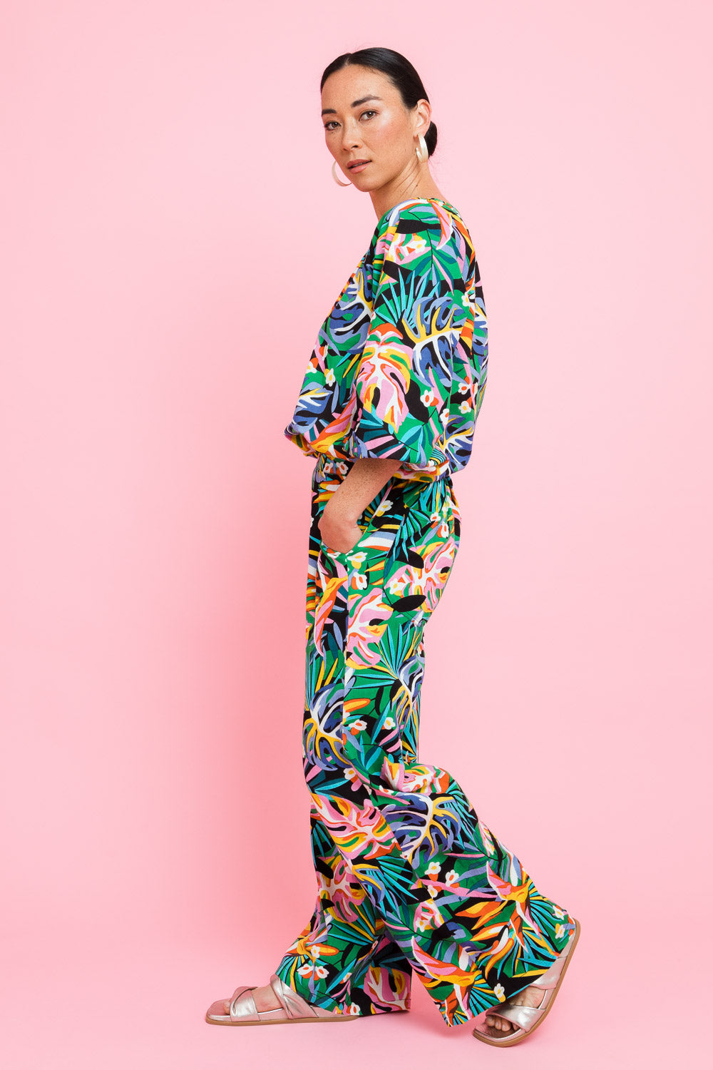 Model Katie wearing size 10 of the Stella Print Pant in colour Rainforest (Blue), from the front, showing the whole outfit