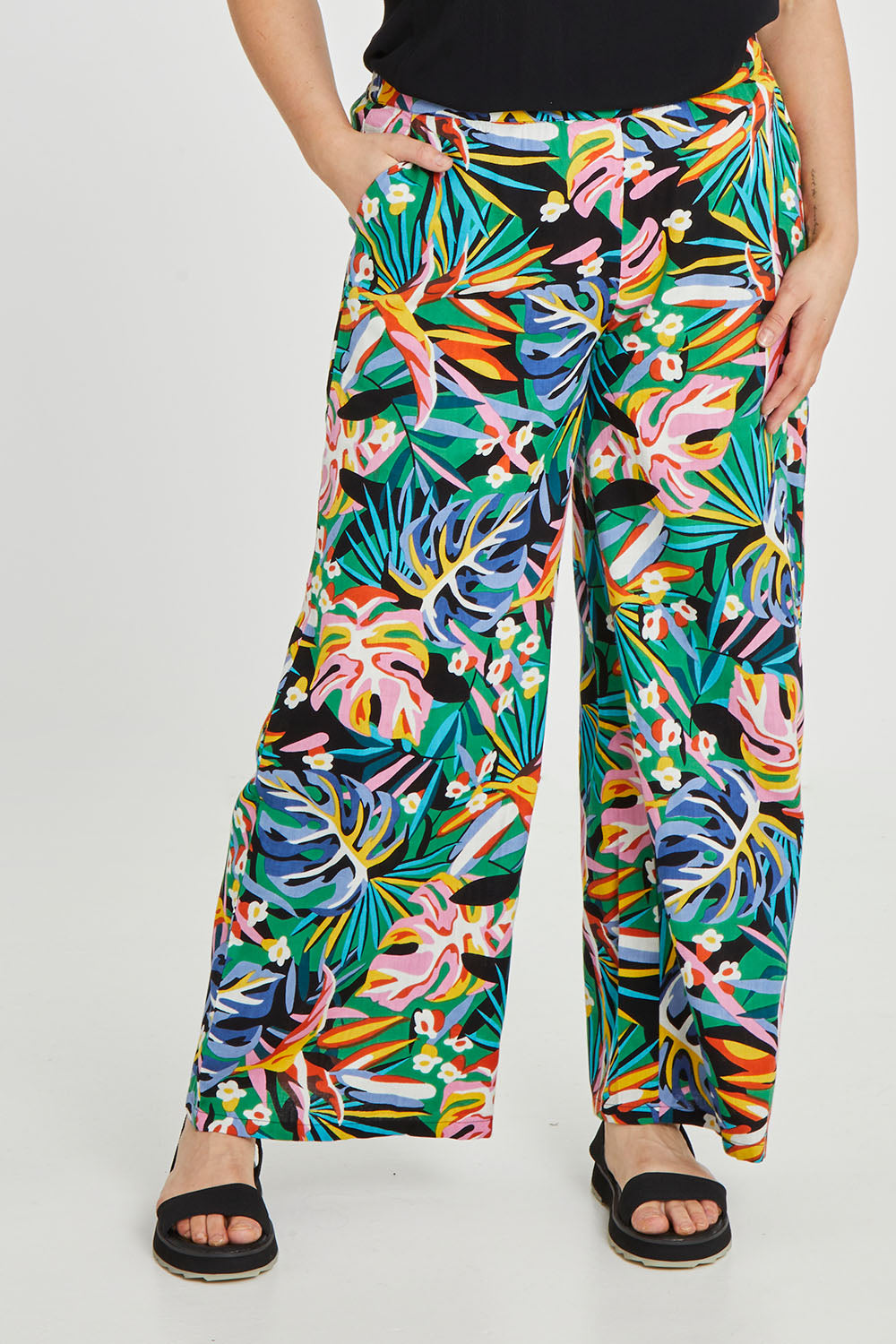 Model Keeara wearing size 16 of the Stella Print Pant in colour Rainforest (Blue), from the front, cropped image