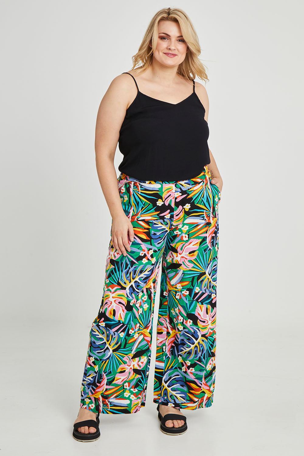 Model Keeara wearing size 16 of the Stella Print Pant in colour Rainforest (Blue), from the front, showing the whole outfit