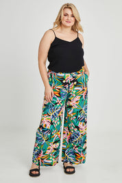 Model Keeara wearing size 16 of the Stella Print Pant in colour Rainforest (Blue), from the front, showing the whole outfit