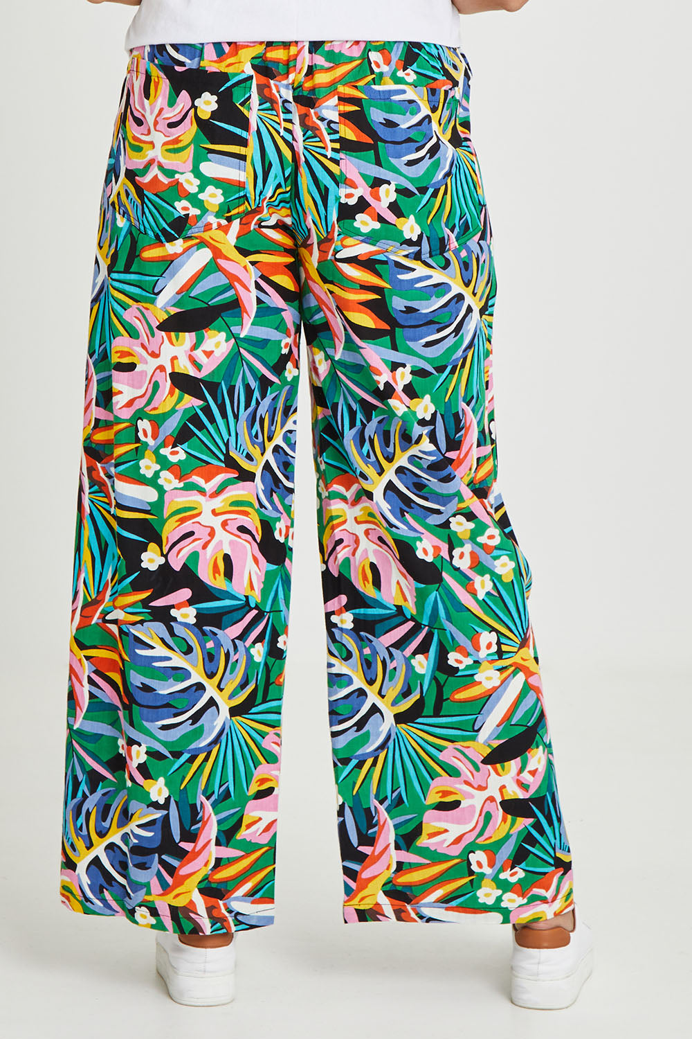 Model Terri-Leigh wearing size 14 of the Stella Print Pant in colour Rainforest (Blue), from the back